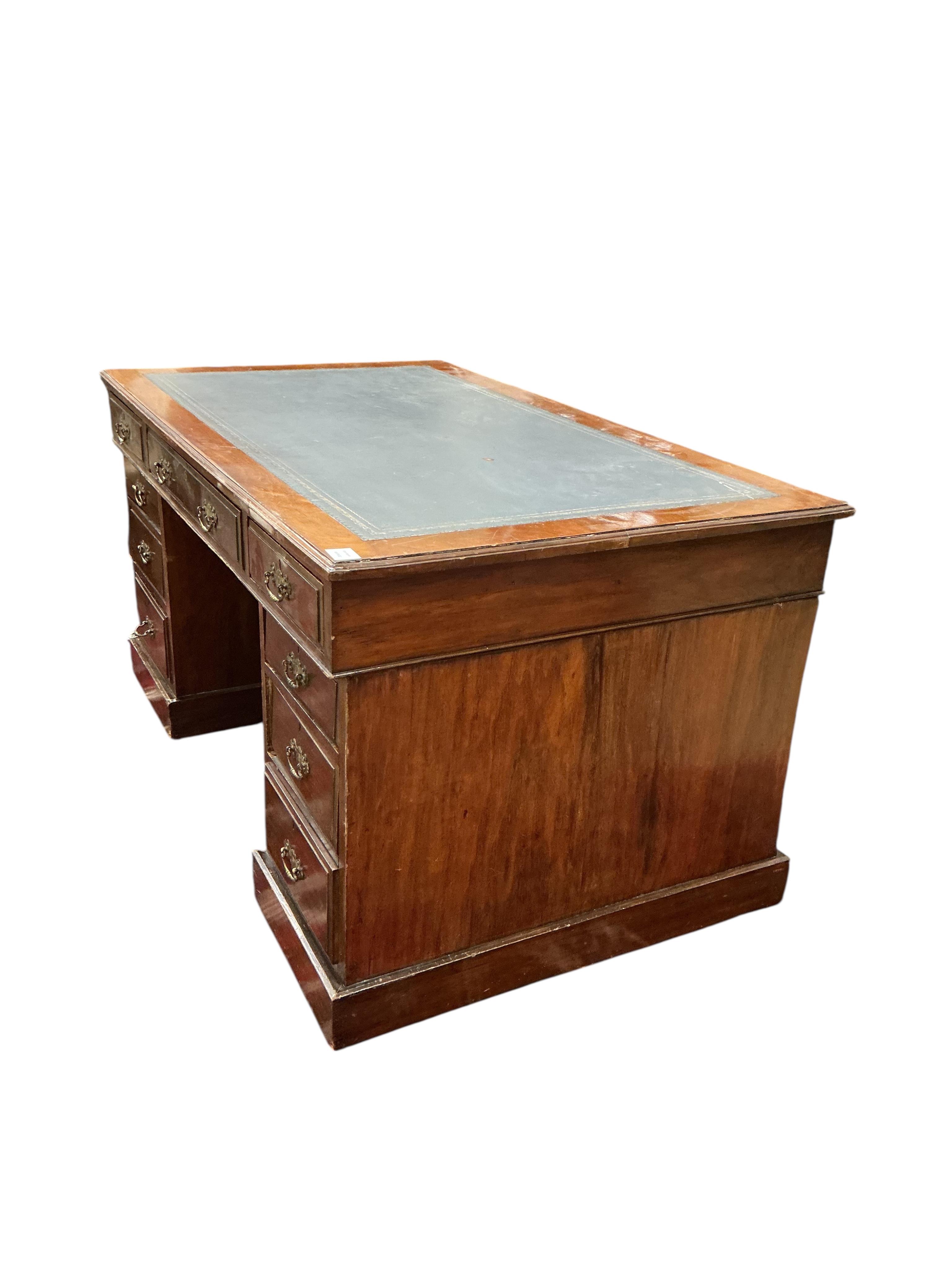 A late Victorian mahogany pedestal desk, fitted nine small drawers, width 138cm, depth 82cm, height 74cm